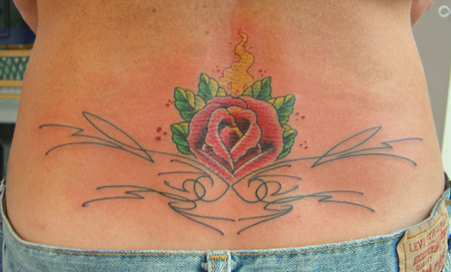 purple rose lower back tattoo. Lower back flower tattoo by Neil Grant of 